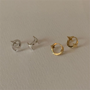 Macro shot showing S925 hallmark on gold and silver hollow dolphin star earrings
