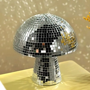 Close-up of silver mushroom disco ball with reflective glass mirror tiles on warm background