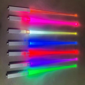 Row of seven colorful glowing LED light sticks with silver handles on dark background