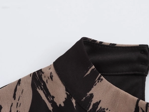 Detailed macro view of high neck collar and brown abstract mesh fabric on a fitted dress