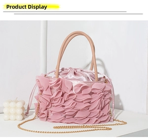 Detail of pink pleated chiffon evening bag with satin lining and gold chain strap