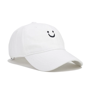 Detail showing the white cotton canvas baseball cap with minimalist black smiley face embroidery