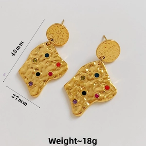 Detailed view of hammered gold geometric earrings with colorful inlaid rhinestones