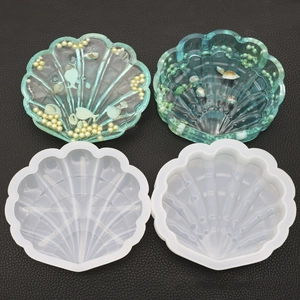 Macro view of shell-shaped silicone mold with green resin seashell storage box