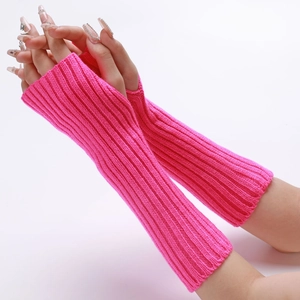 Detail of neon pink ribbed knit arm warmers with thumb holes and textured finish