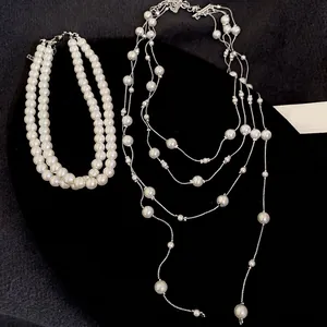 Elegant French vintage layered pearl necklace featuring cream white tassels and silver clasp