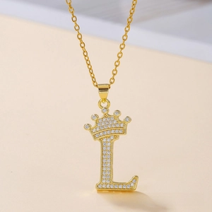 Macro view of gold-plated letter L pendant with crown and white zircon inlay details