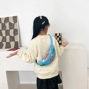 Kids blue dinosaur print chest bag with adjustable strap worn by a child model
