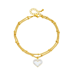 Double-layered gold anklet with metallic beads and sparkling rhinestone heart pendant