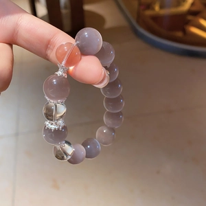 Detailed close-up of cat eye stone beads with vintage floral silver spacers on bracelet