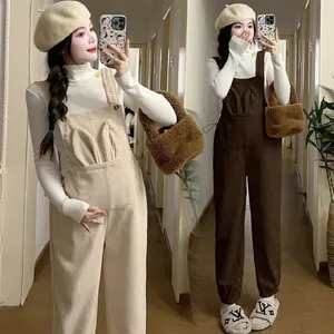 Pink corduroy maternity overalls with adjustable waist and cute rabbit ear pocket detail