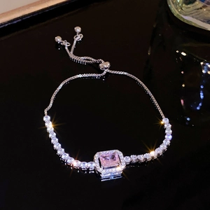 Macro detail of adjustable silver bracelet with pink rectangular zircon and pavé setting