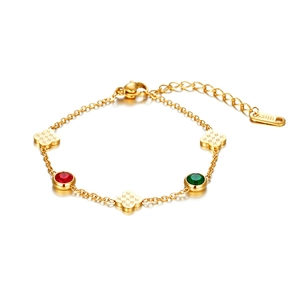 Detail of 18K gold-plated stainless steel bracelet with red green stones and clover charms