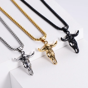 Detailed view of bull skull pendants in silver, gold, and black finishes with bead chains