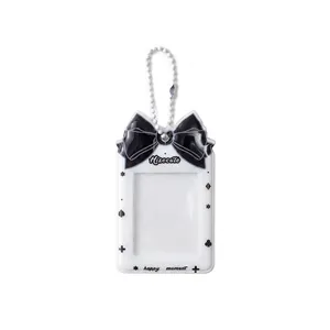 White PVC photo card holder with black ribbon bow and beaded chain for kpop photocard