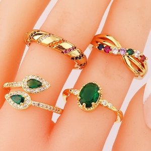 Gold-plated rings set with emerald-cut green zircon and multicolor stones on model