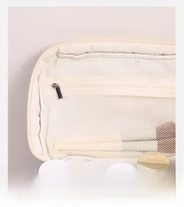 Detail showing the inner mesh zipper pocket and organized cosmetic storage compartments