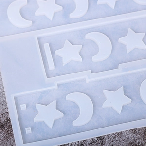 Macro detail of translucent silicone mold with crescent moon and star shapes for DIY resin
