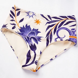 Detail of high-waisted bikini bottoms with ethnic floral print and star patterns