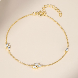Detail of golden S925 sterling silver bracelet with teardrop zircon and lobster clasp