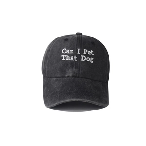 Close-up of Can I Pet That Dog embroidery on a washed charcoal cotton baseball cap