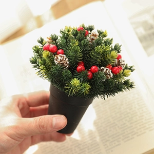 Mini 13cm frosted Christmas tree in a black pot with red berries and pine cones