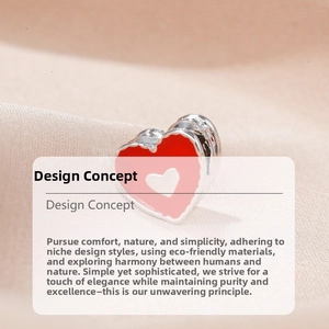 Macro view of heart-shaped enamel charm with red and pink tones on silk texture