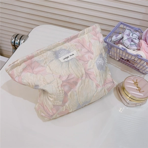 Detail of pink bubble floral jacquard makeup bag with Simple Wish woven label