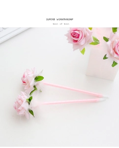 Close-up of pink rose flower pens with delicate white feathers and sleek pink barrels