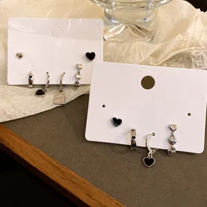 6-piece silver heart stud earring set with black and white minimalist enamel charms