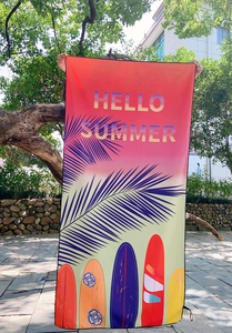 Close-up of Hello Summer quick-dry beach towel with surfboard and palm leaf prints