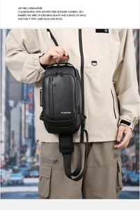 Close-up of black crossbody bag with built-in USB charging port and pebbled texture