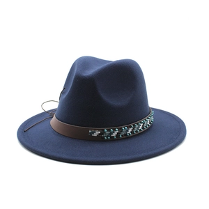 Detail of navy wool fedora hat featuring a brown leather band with ethnic beadwork