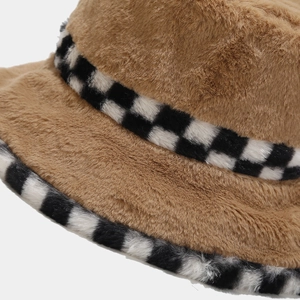 Close-up of brown plush bucket hat featuring stylish black and white checkerboard trim