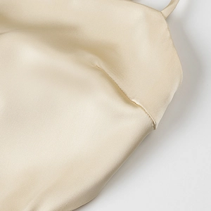 Elegant champagne satin dress featuring a cowl neck and fine silk texture details