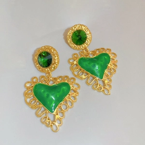 Vintage gold heart earrings with green resin and rhinestones on a clean white background