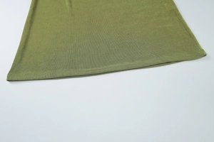 Detailed close-up of the olive green knitted hemline on this slim fit maxi tube dress