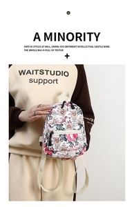 Detail of floral print mini backpack featuring white canvas and adjustable straps