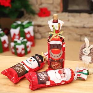 Christmas wine bottle covers with Santa, snowman, and reindeer motifs for holiday table decor