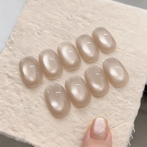 Short oval cat eye press-on nails in nude ice-translucent pearl glass bead finish
