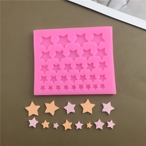 Pink silicone mold featuring multiple size star shapes for baking and fondant cake decor