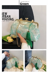 Macro detail of green floral embroidery texture with elegant silk tassel on shell bag