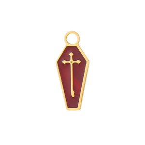 Macro shot of coffin-shaped pendant with red enamel and gold cross for jewelry making