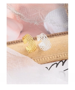 Detail of woven mesh texture on adjustable silver and gold wide band rings