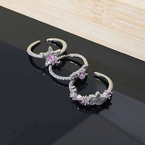Detail of pink star and heart zircon stones on adjustable silver-toned metal rings