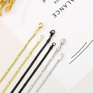 Three minimalist titanium steel snake chains in gold, black, and silver with lobster clasps