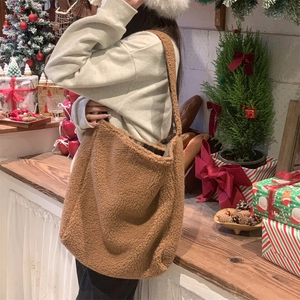 Close-up of brown teddy fleece tote bag with plaid lining in a festive Christmas setting