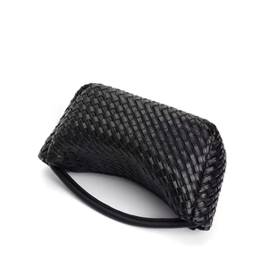 Detailed view of black woven leather handbag showing intricate intrecciato craftsmanship