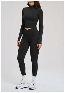 Detail of black sports set featuring a zipper stand collar jacket and cross V-waist leggings