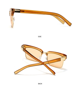 Detail view of tortoiseshell frame with golden metal hinges and amber lenses